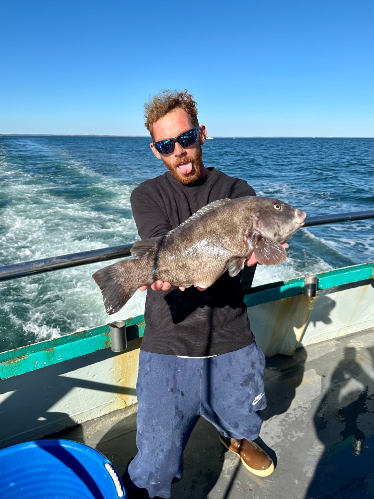 a man holding a fish in the water