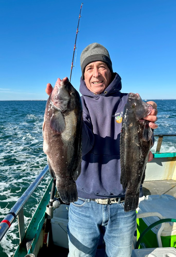 a person holding a fish in the water