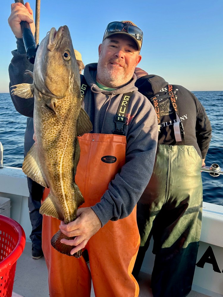 a man holding a fish in the water