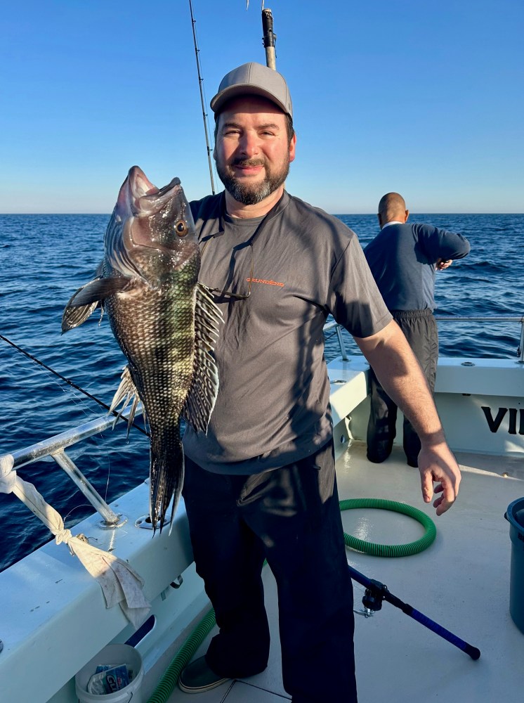 a person holding a fish in the water