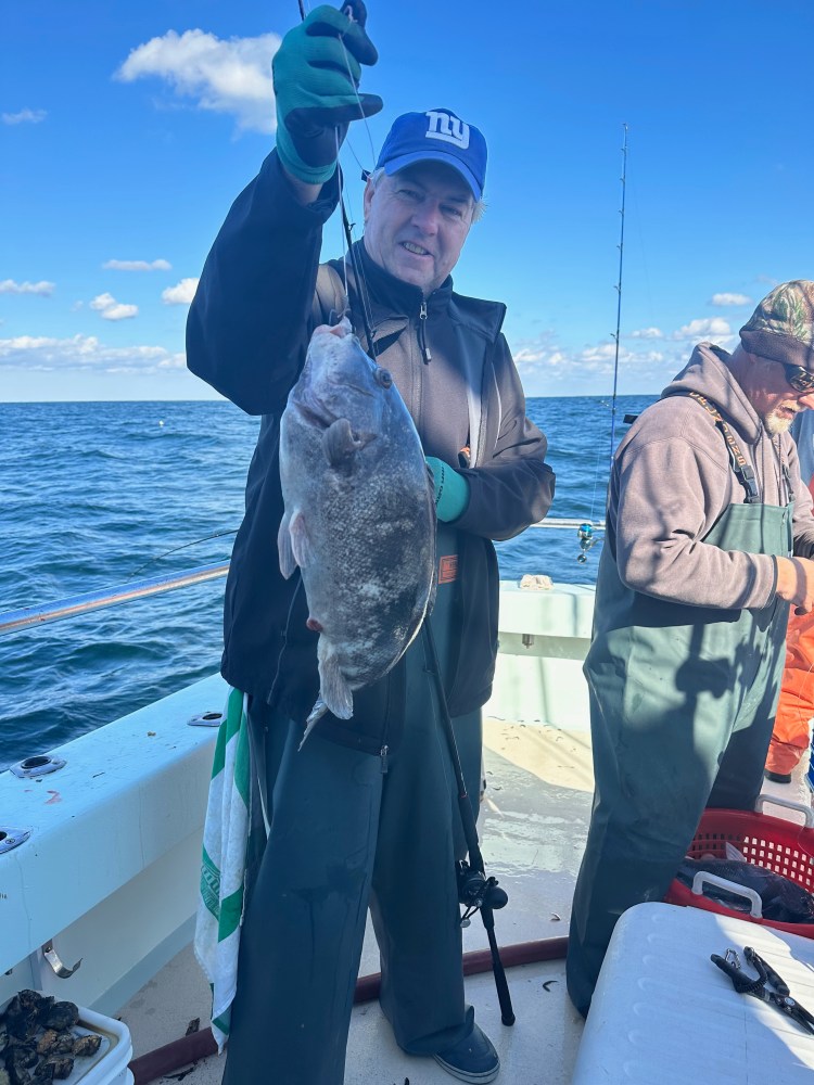 a person holding a fish in the water