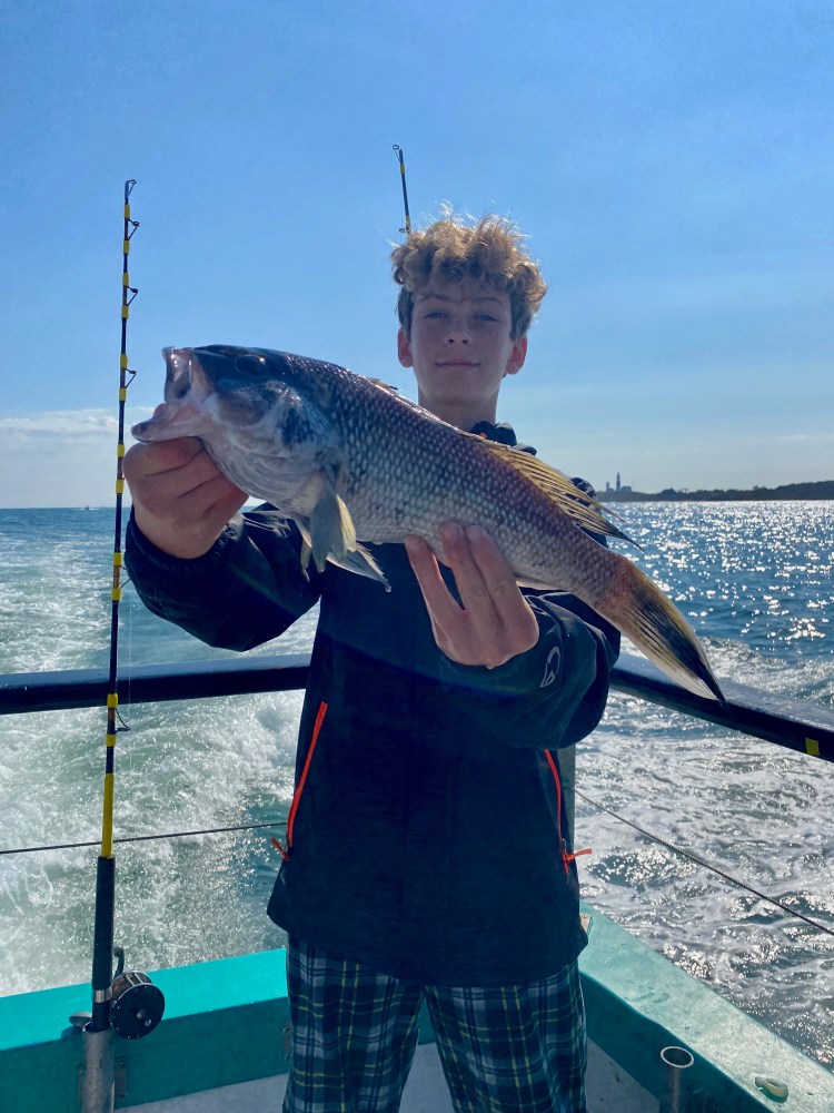 a person holding a fish in the water