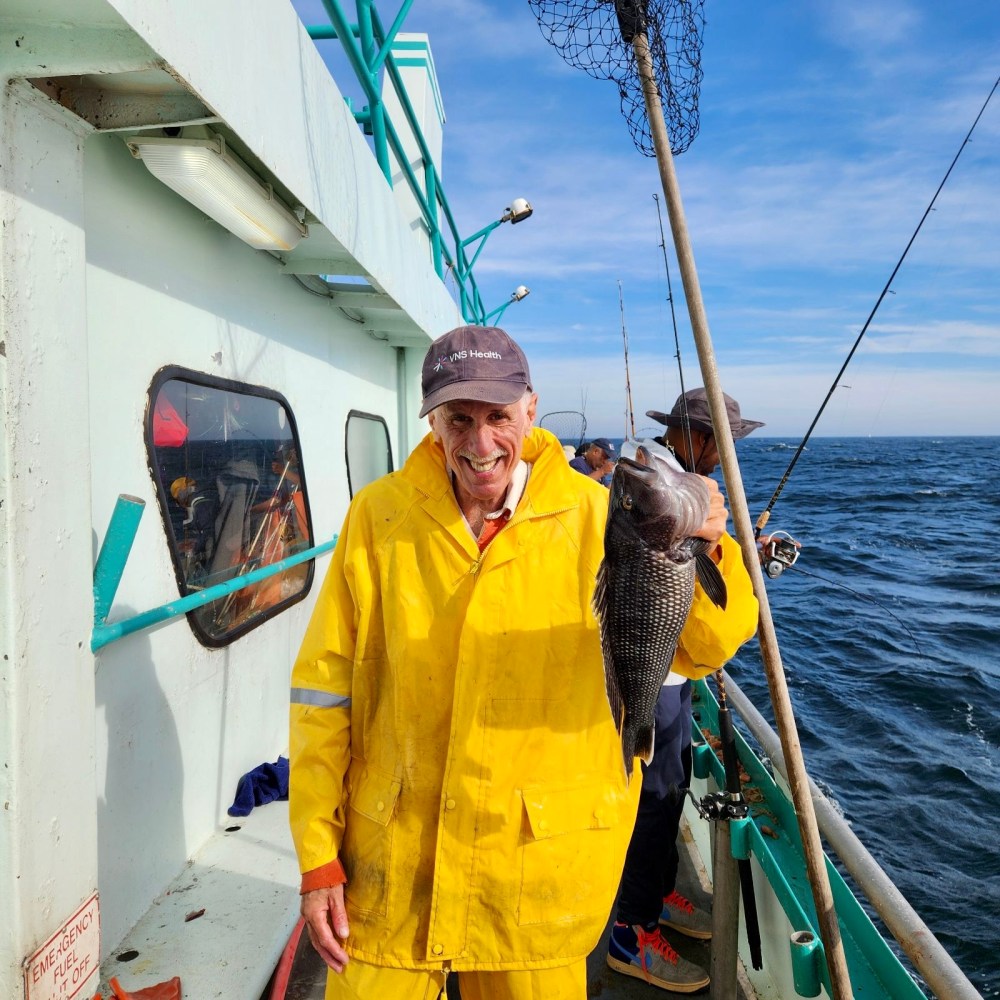 a man standing on a boat in the water