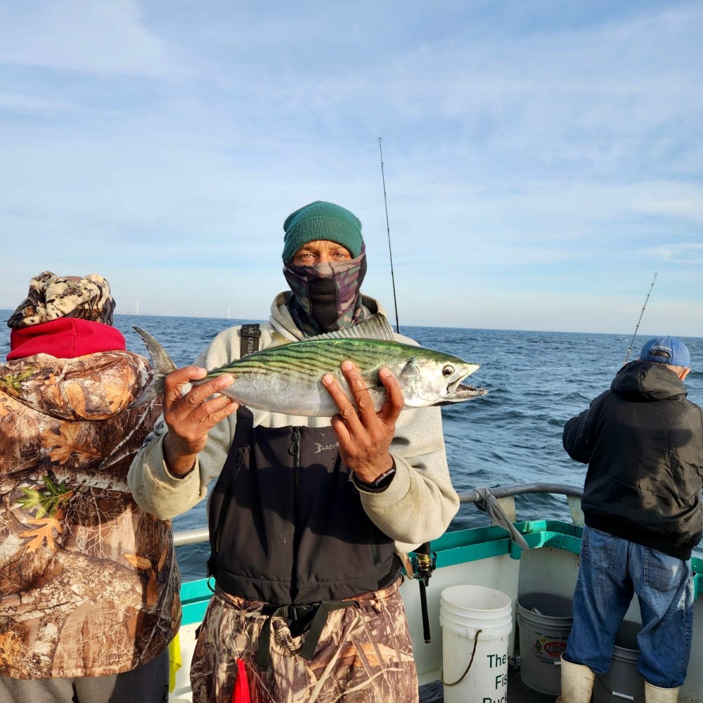 a man holding a fish in the water