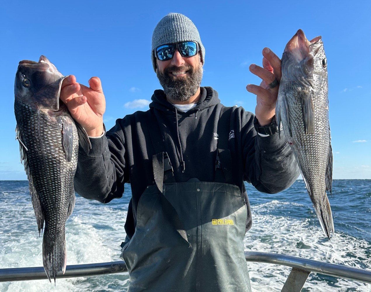 a man holding a fish in the water