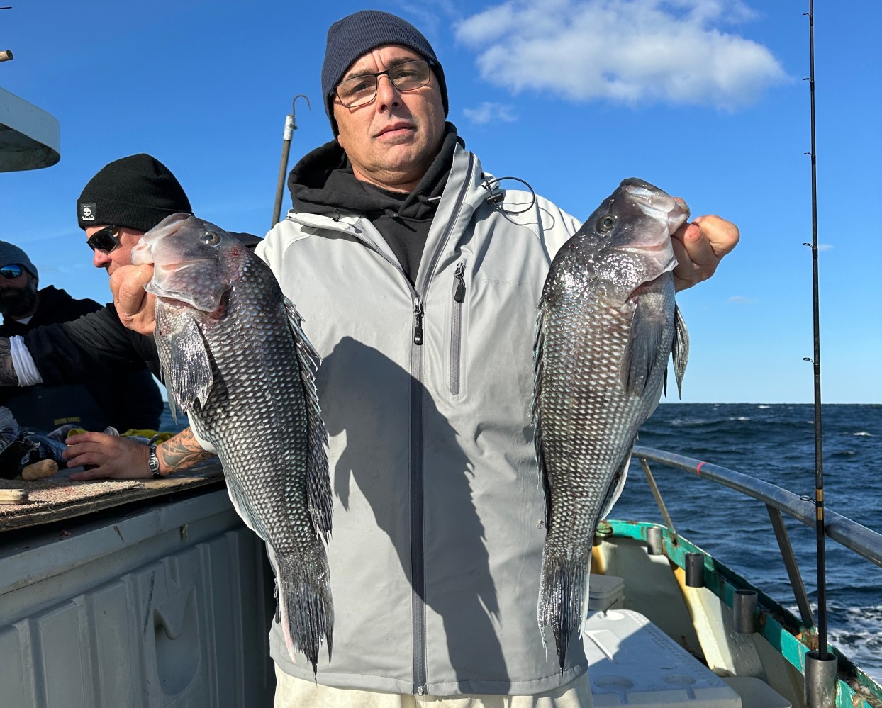 a man holding a fish in the water