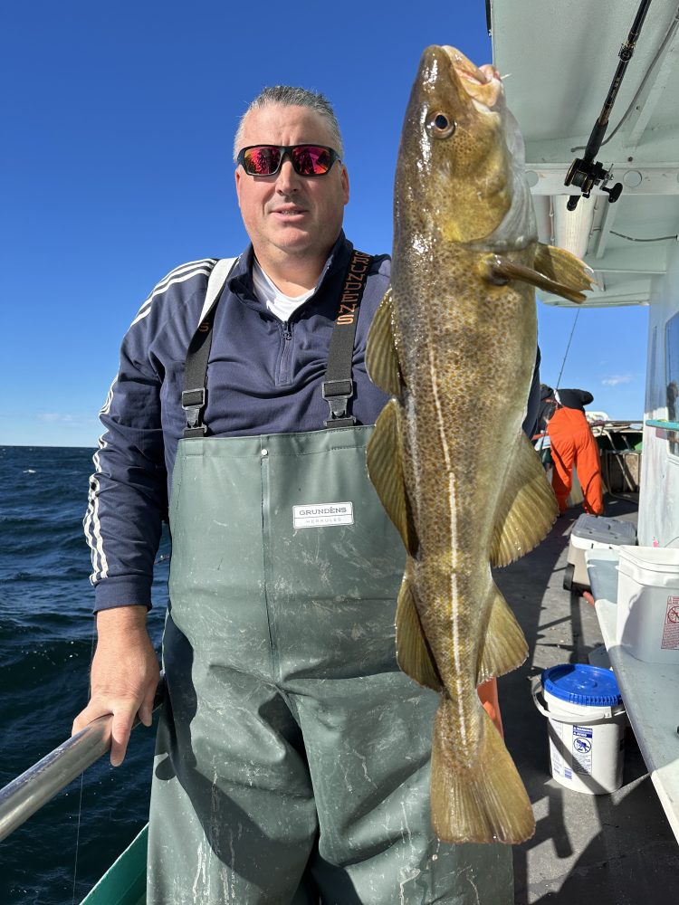 a man holding a fish