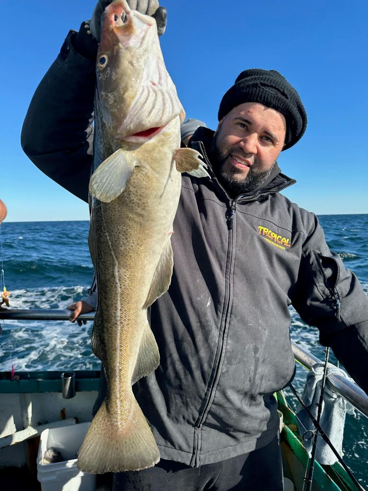 a man holding a fish in the water