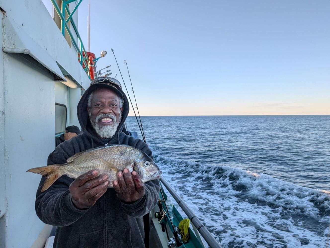 a man holding a fish in the water