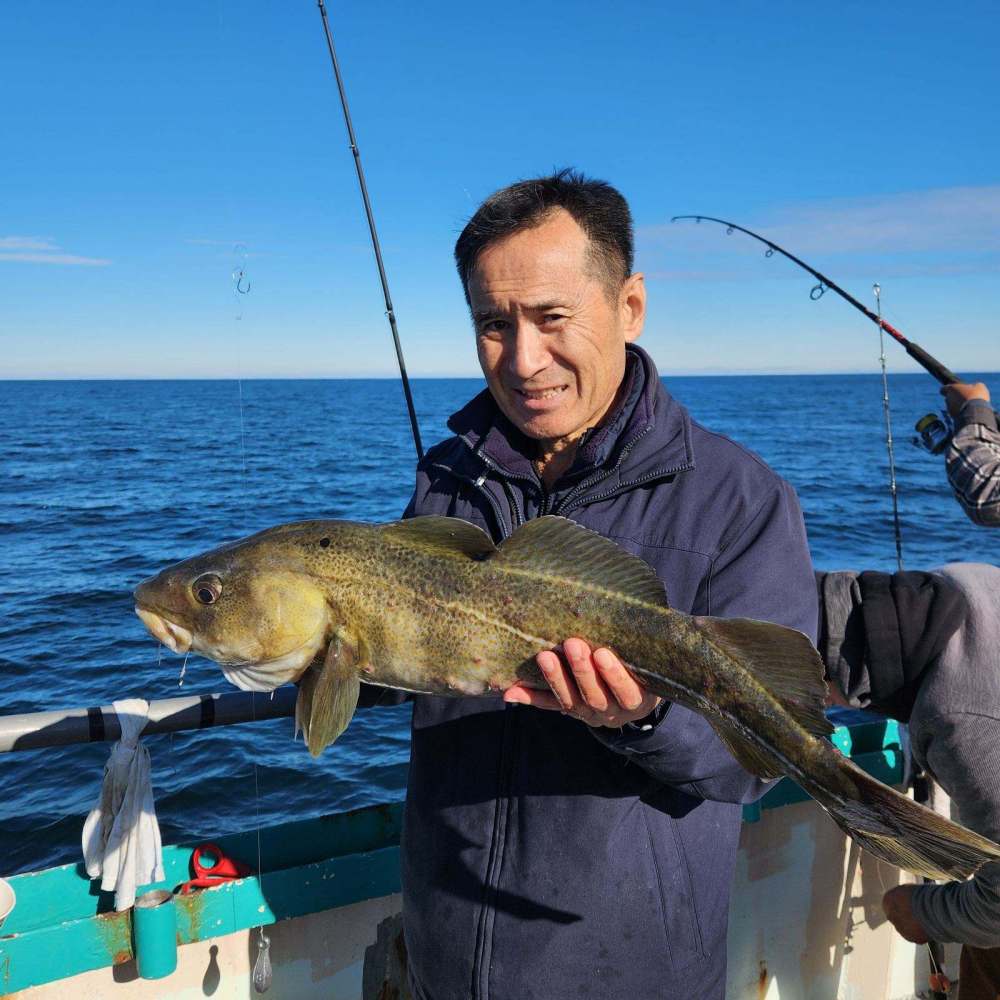 a man standing next to a body of water