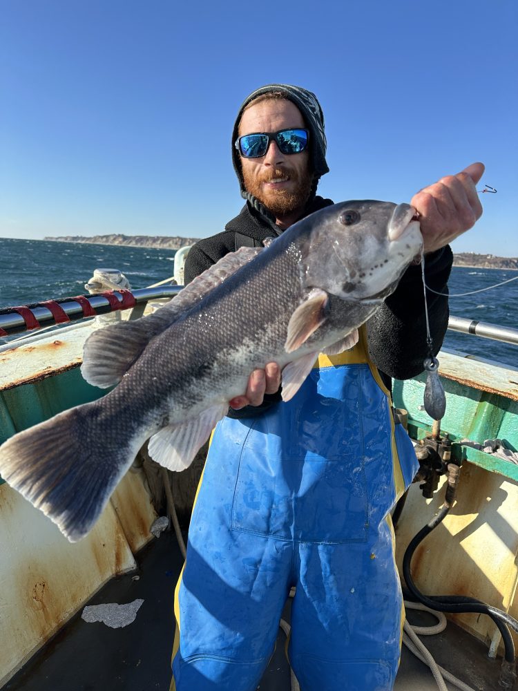 a man holding a fish in the water