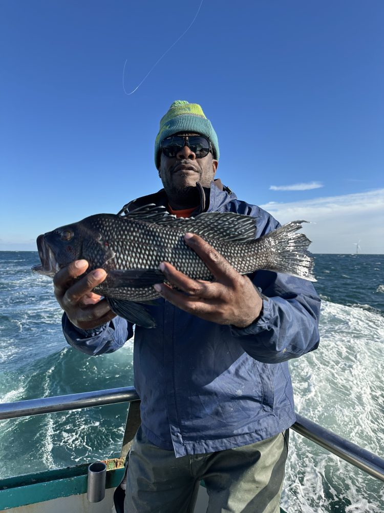 a man holding a fish in the water