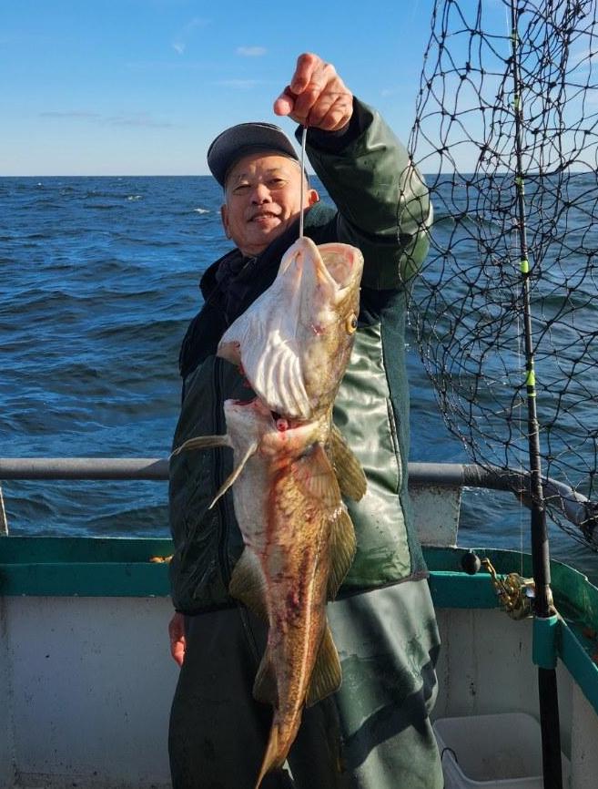 a man holding a fish in the water