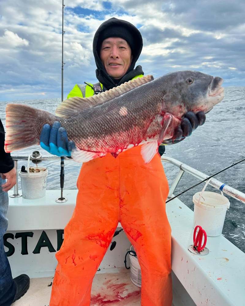 a person holding a fish in the water