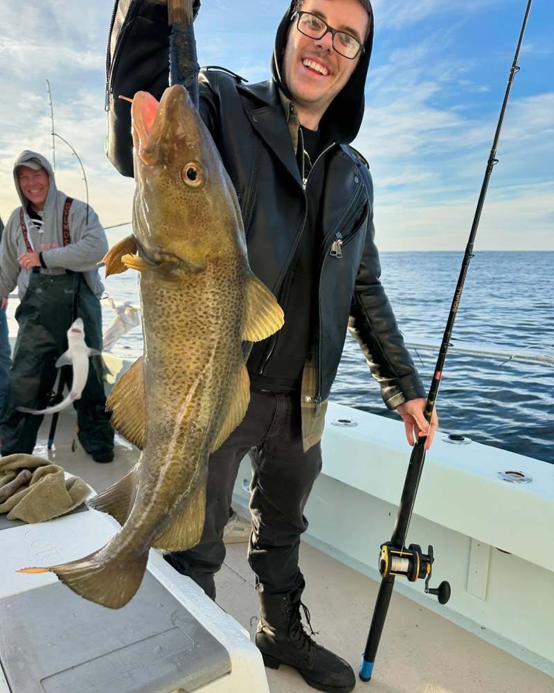 a person holding a fish in the water