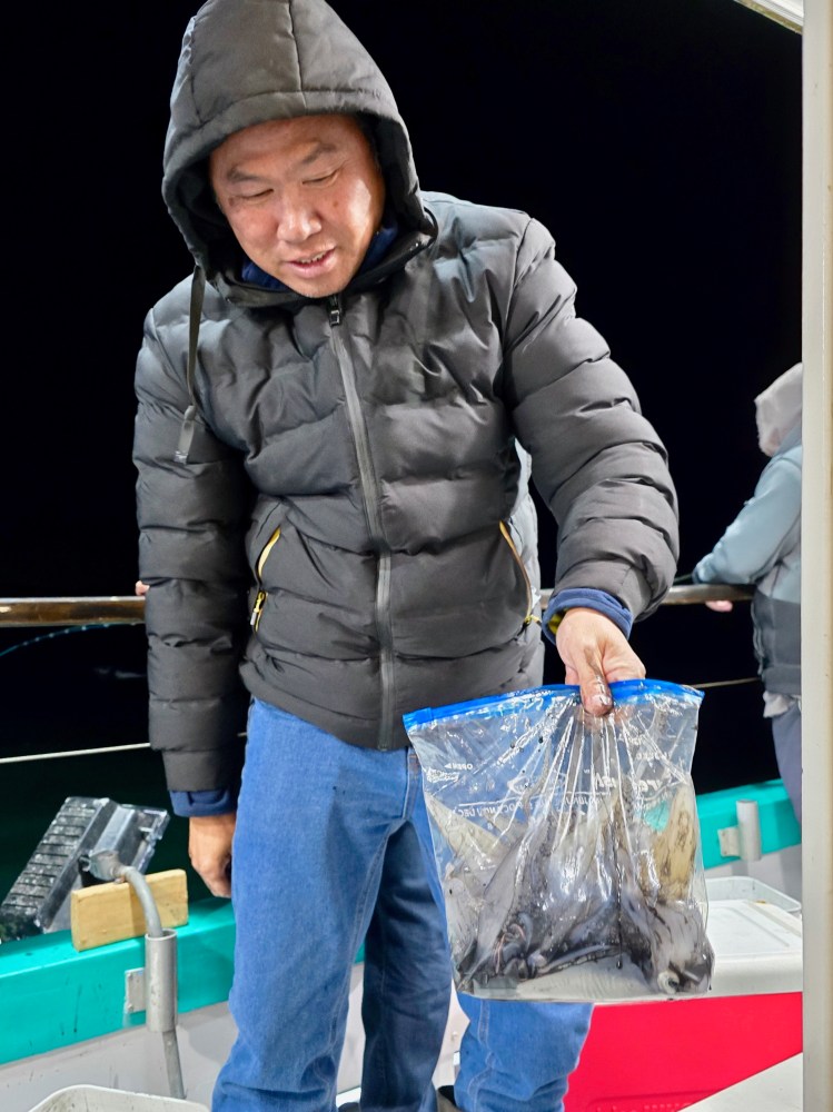 a person standing next to a suitcase