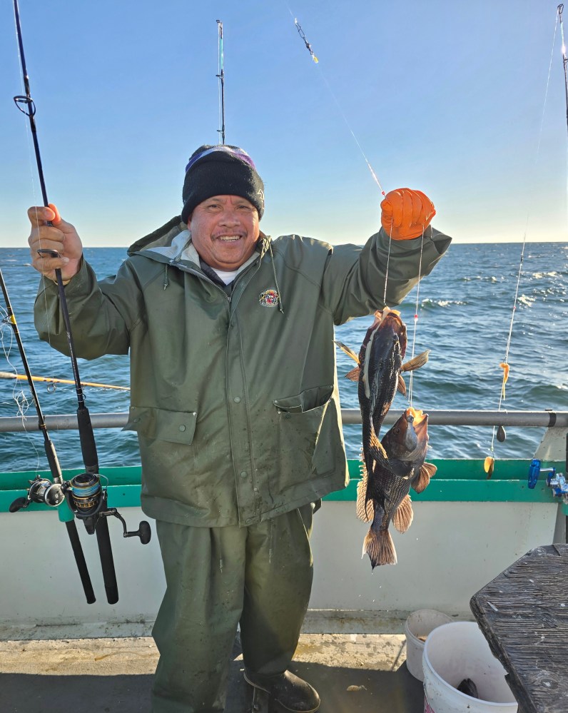 a man holding a kite in a boat on the water