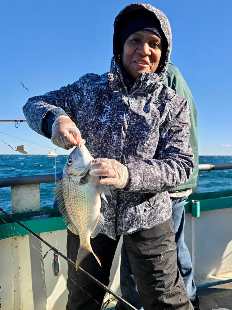 a man holding a fish in the water