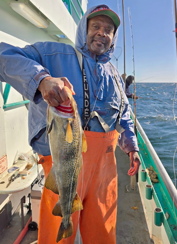 a person holding a fish in the water