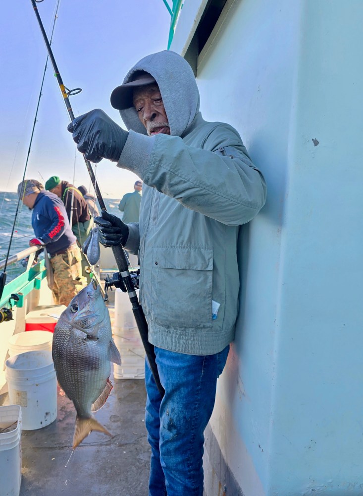 a man holding a fish