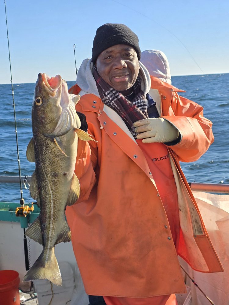 a man holding a fish in the water