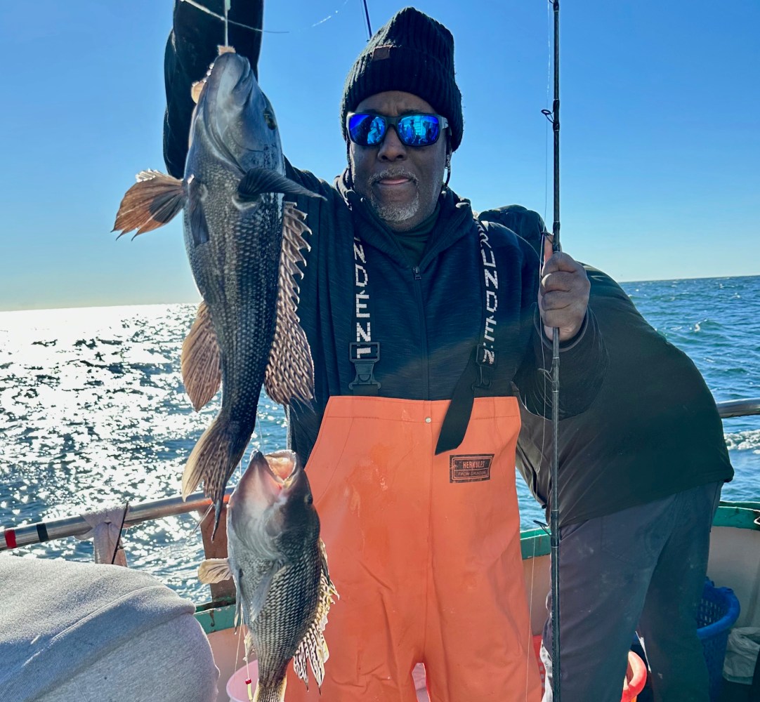 a person holding a fish in the water