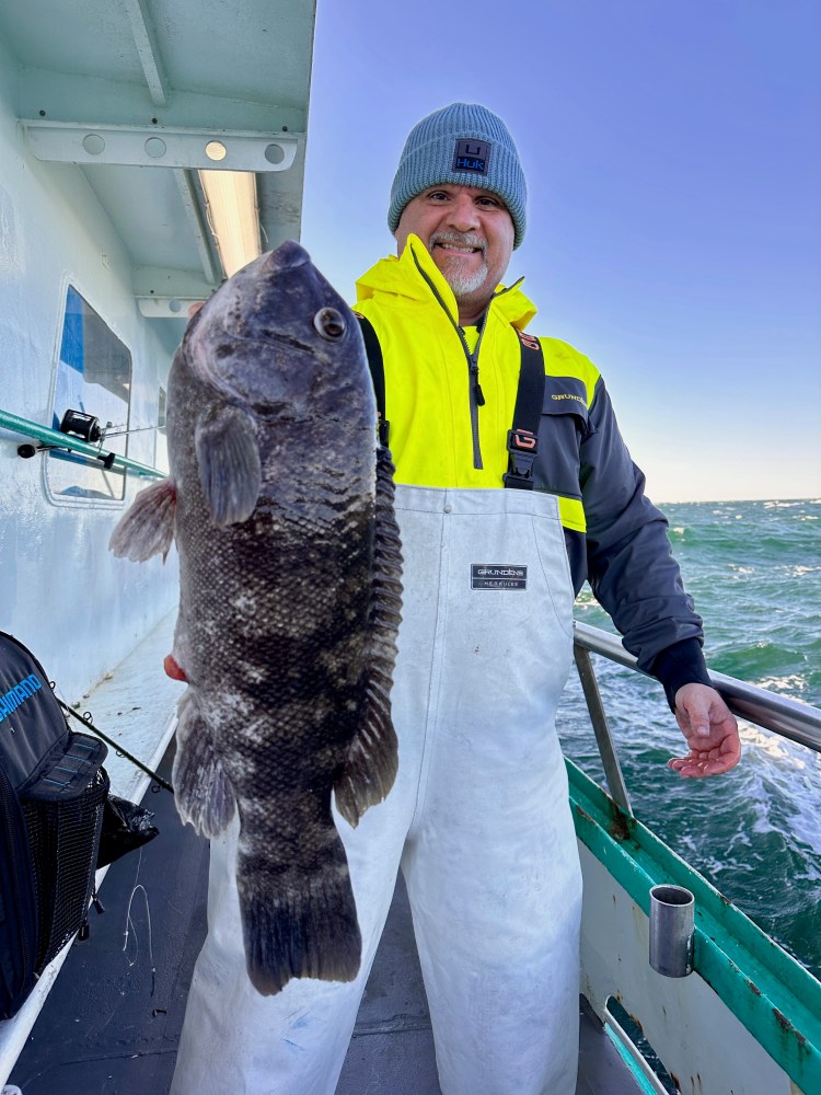 a man holding a fish