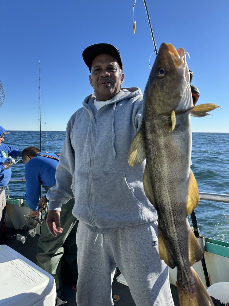 a person holding a fish in the water