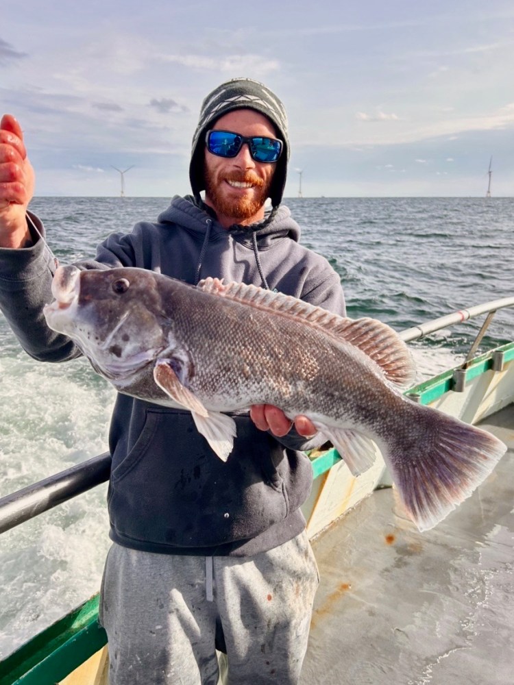 a person holding a fish in the water