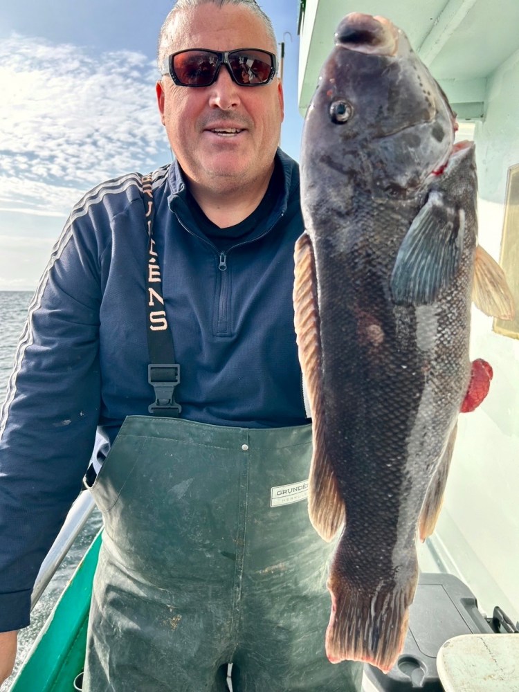 a man holding a fish