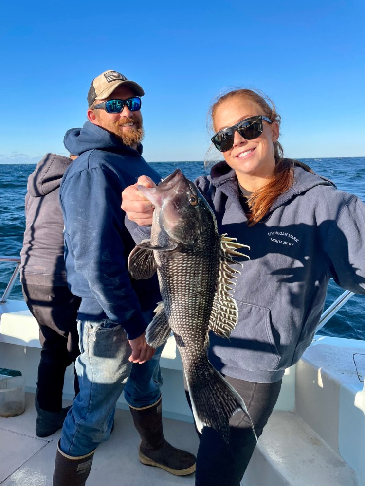 a person holding a fish in the water