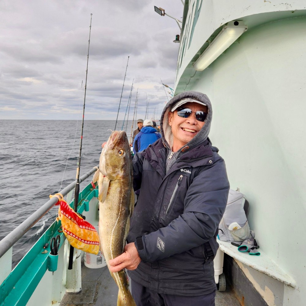 a person holding a fish on a boat