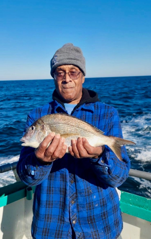 a man holding a fish in the water