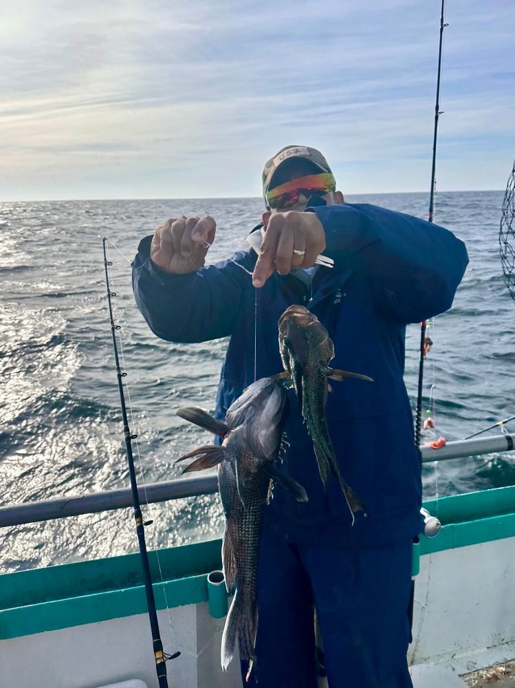 a person holding a fish in the water