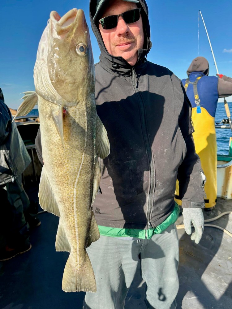 a person holding a fish