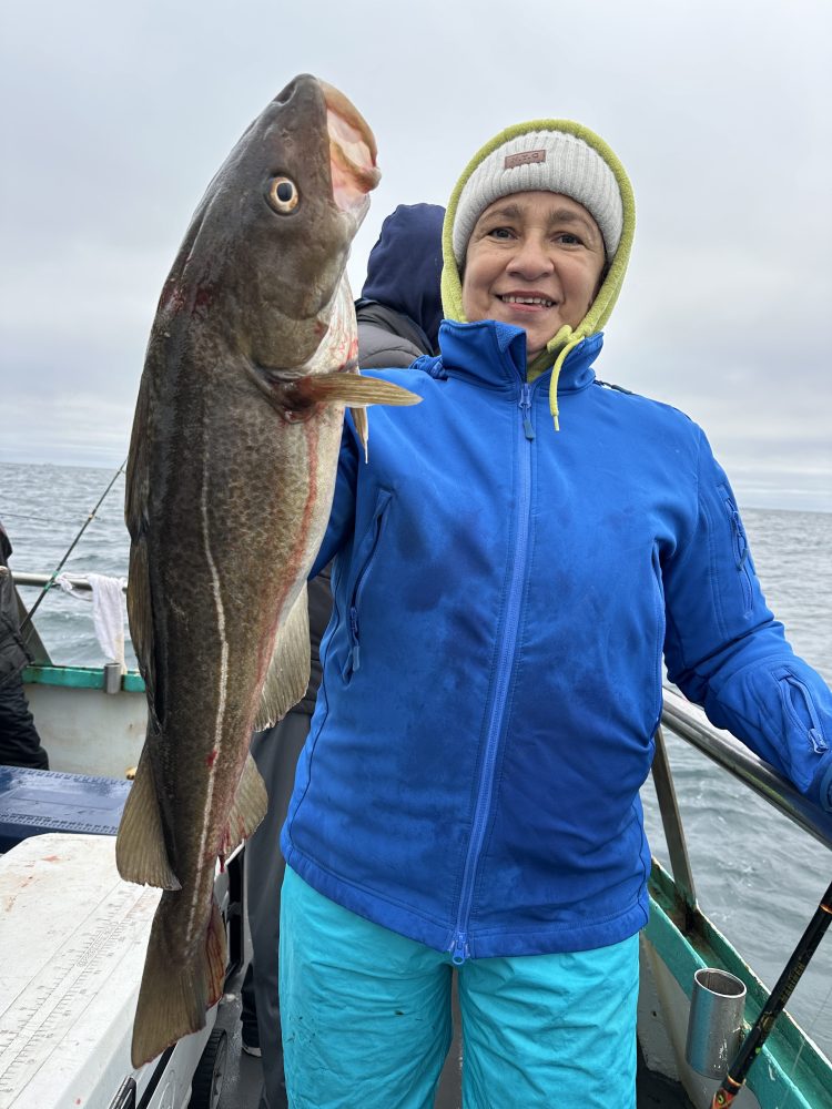 Amina J. Mohammed holding a fish in the water