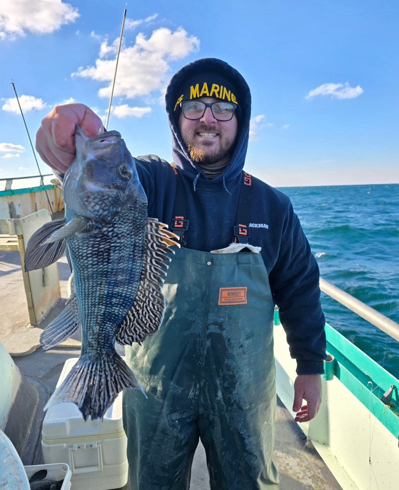 a person holding a fish in the water