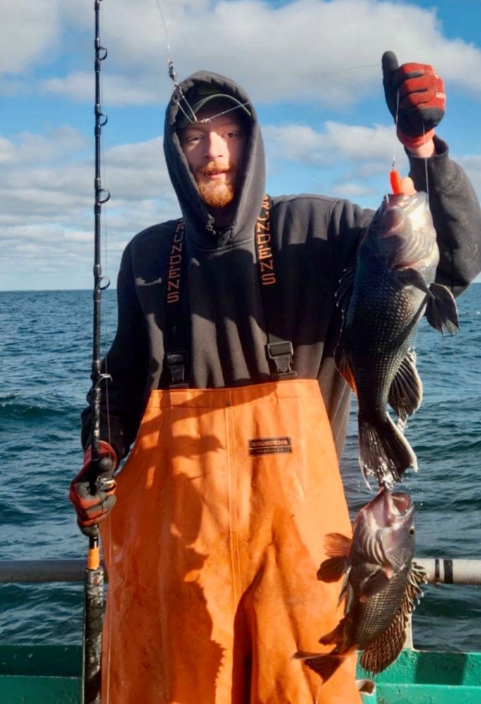 a person holding a fish in the water