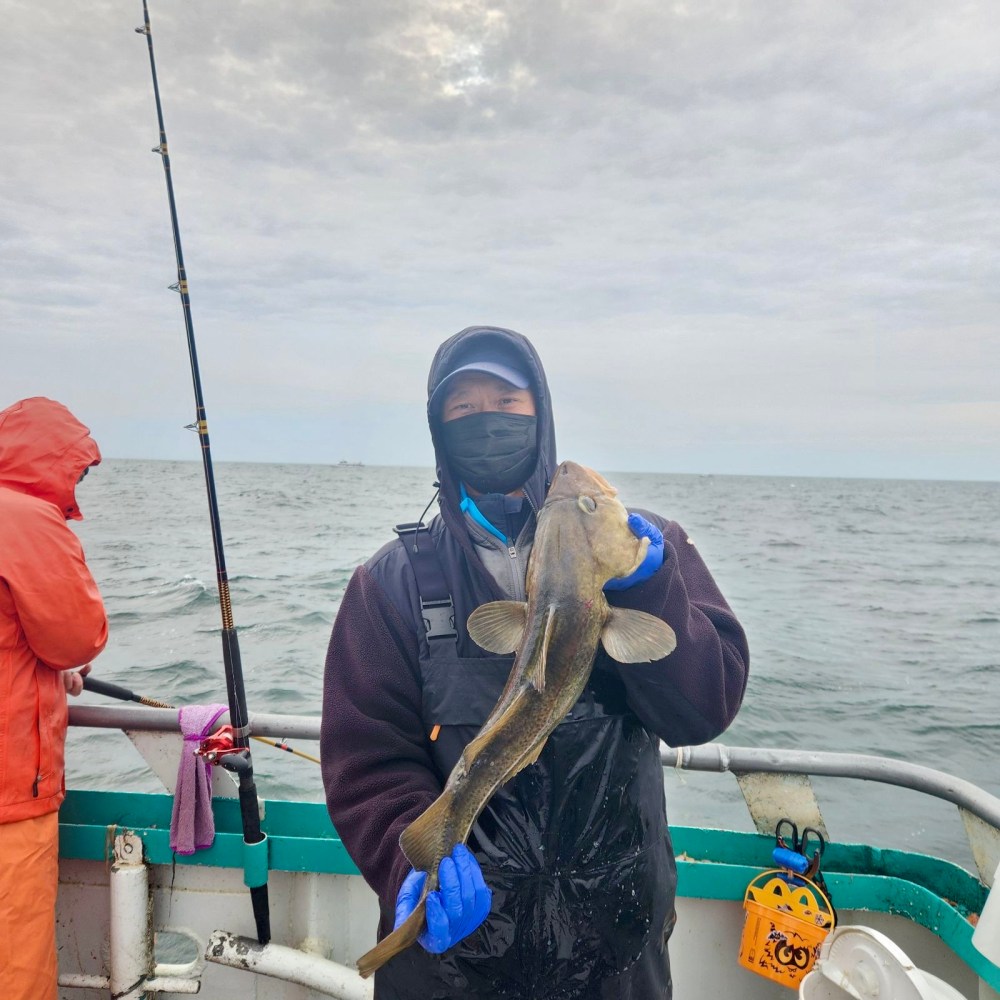 a person holding a fish on a boat in the water