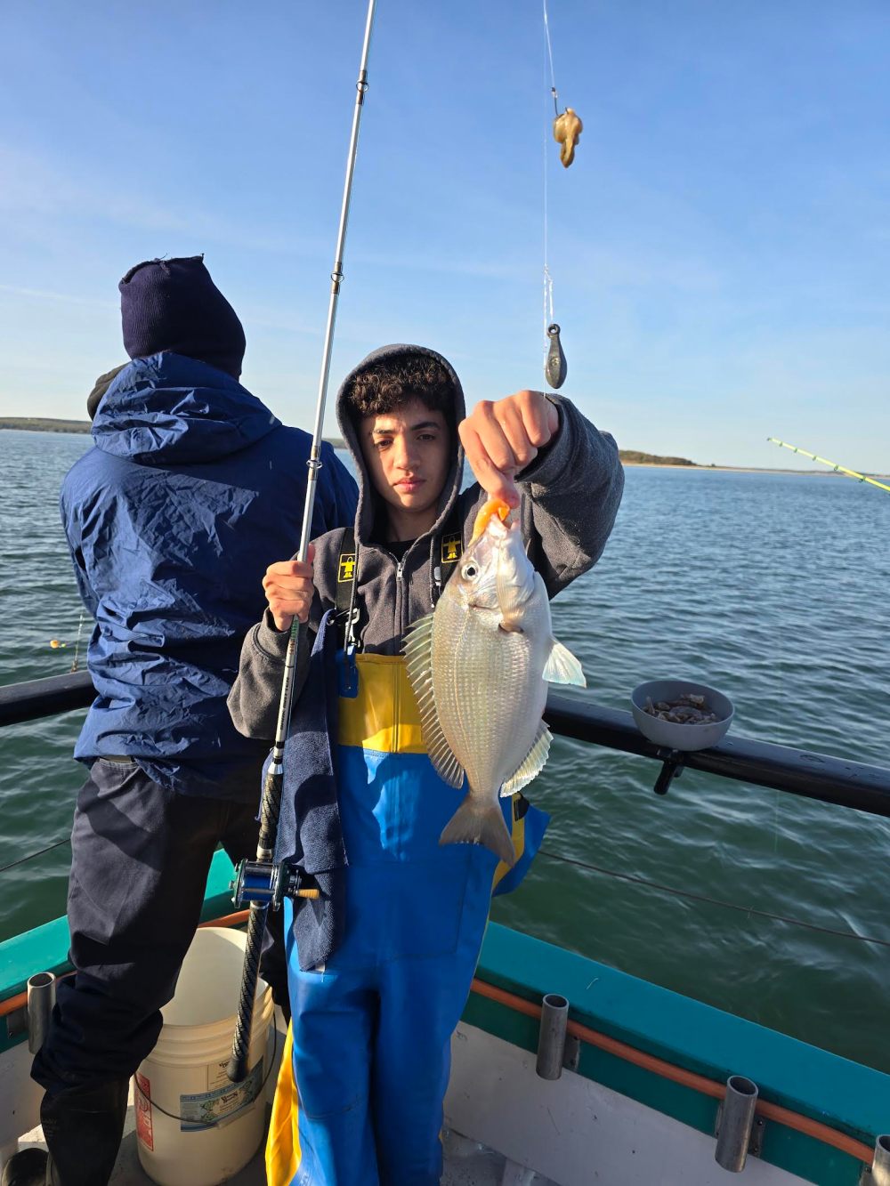 a person standing next to a body of water