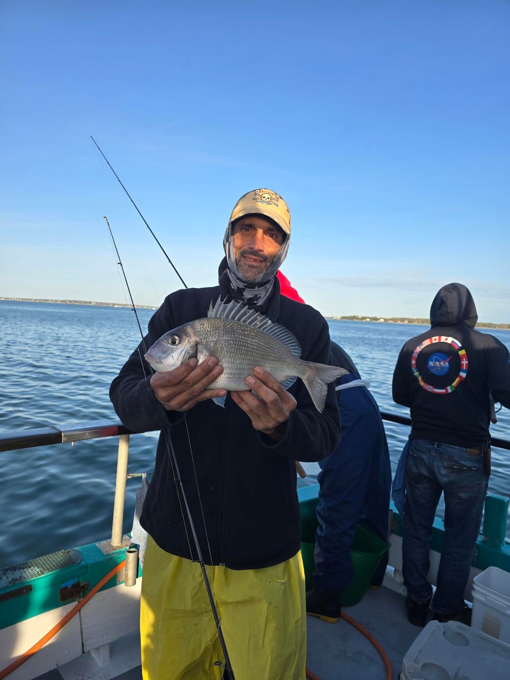 a man standing next to a body of water