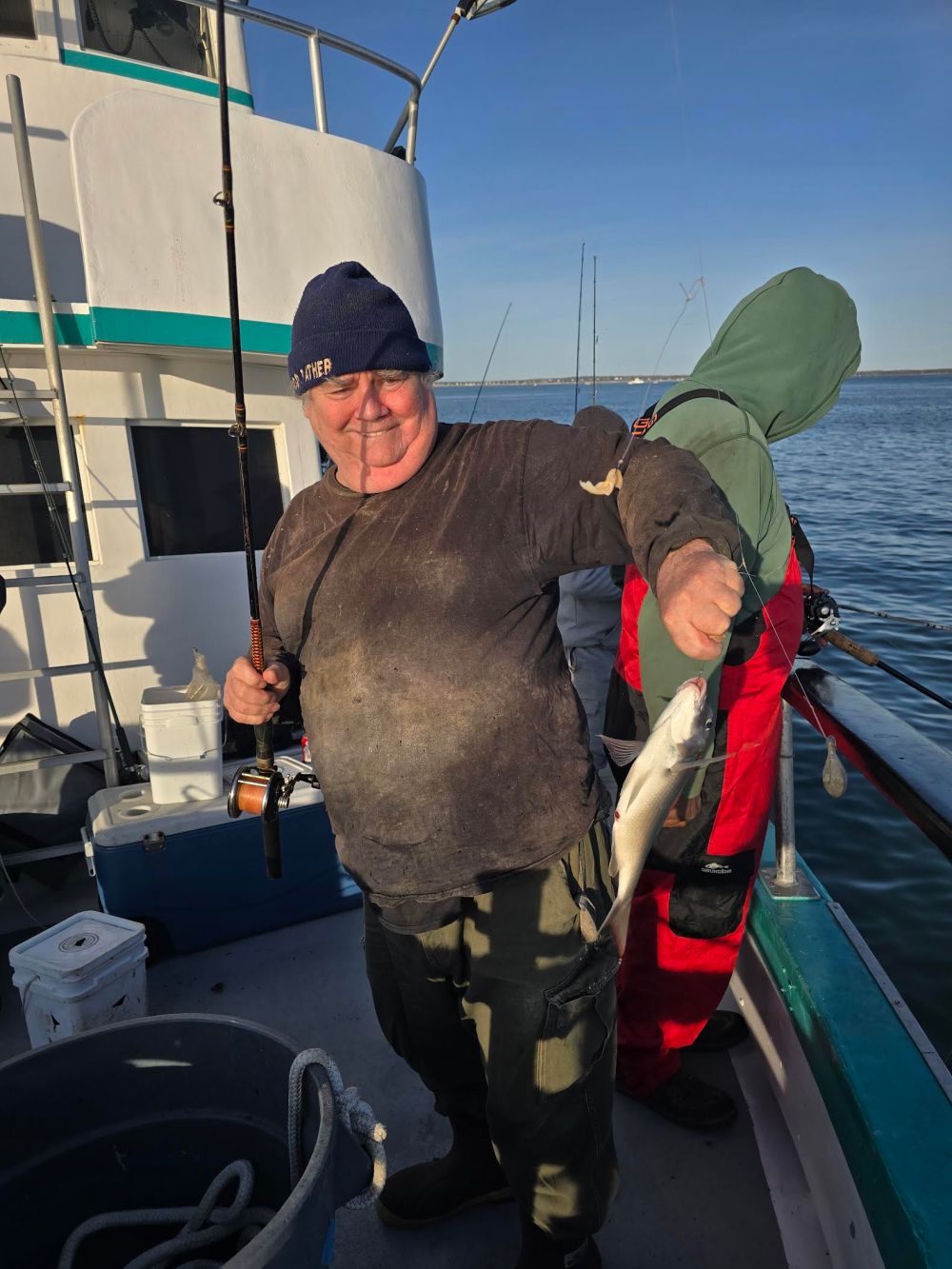 a man standing next to a boat