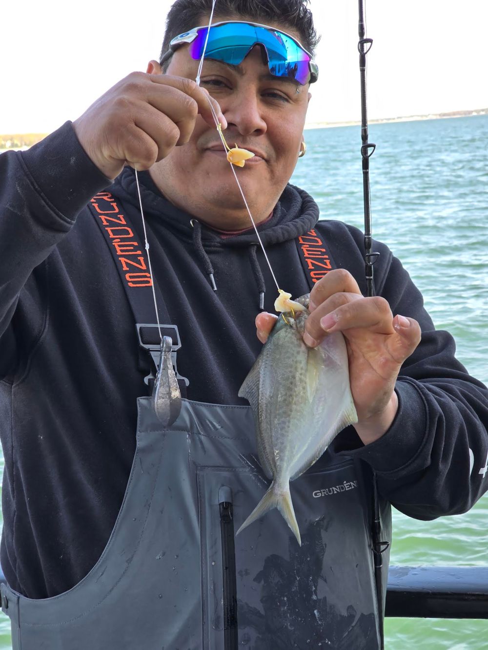 a person wearing a hat and sunglasses holding a bottle of water