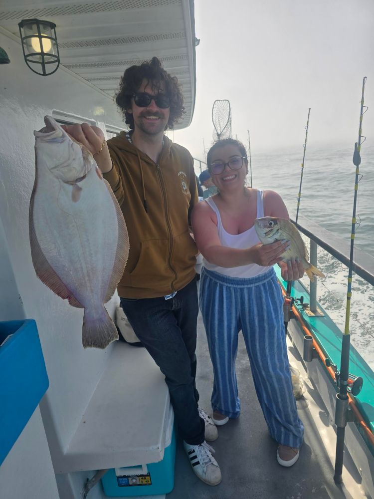 a man and a woman standing on a boat