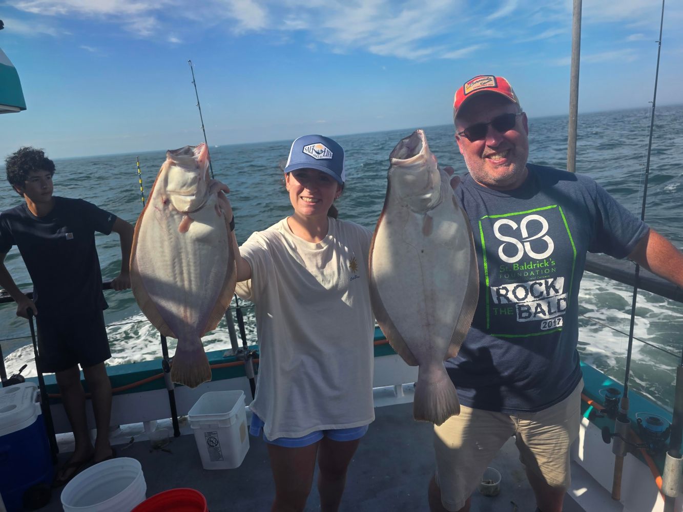 a man holding a fish in the water