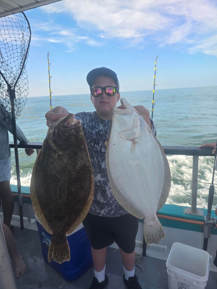 a man holding a fish in the water