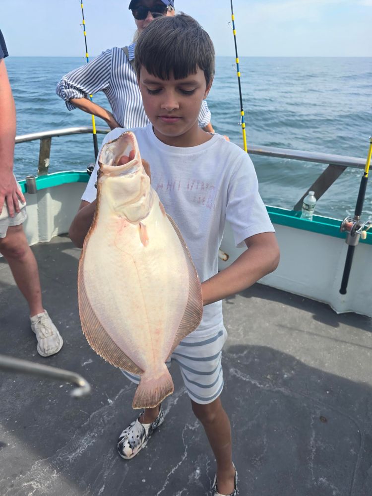 a person holding a fish in the water