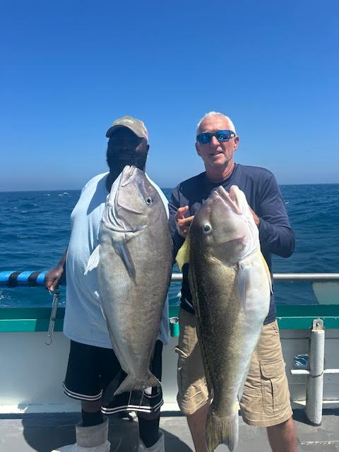 a man holding a fish in the water