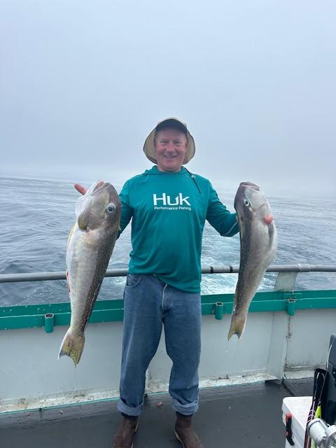 a person holding a fish in the water
