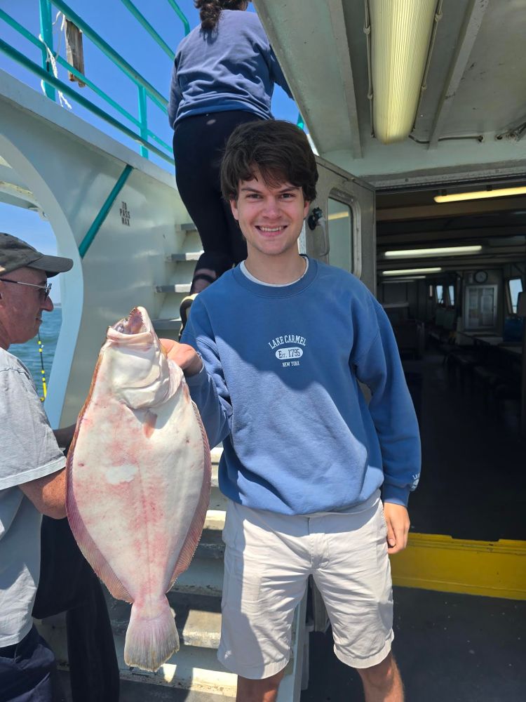 a man holding a fish
